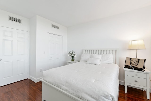 bedroom featuring dark hardwood / wood-style flooring and a closet