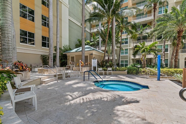 view of pool featuring a community hot tub and a patio