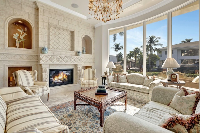 dining space featuring a chandelier, a high ceiling, decorative columns, and a raised ceiling