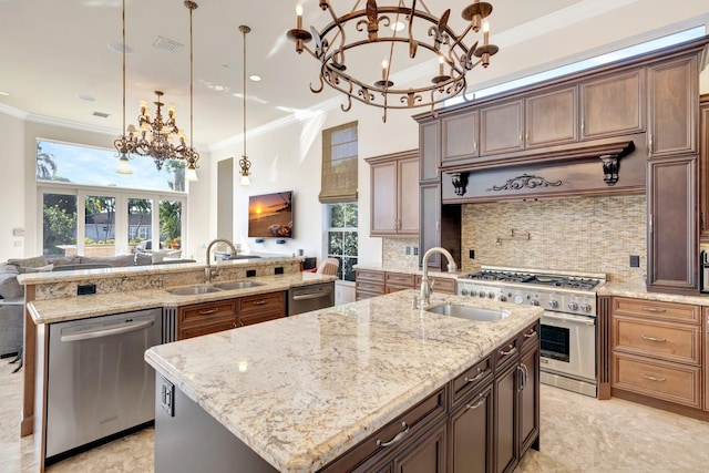 kitchen featuring pendant lighting, dishwasher, sink, and an island with sink