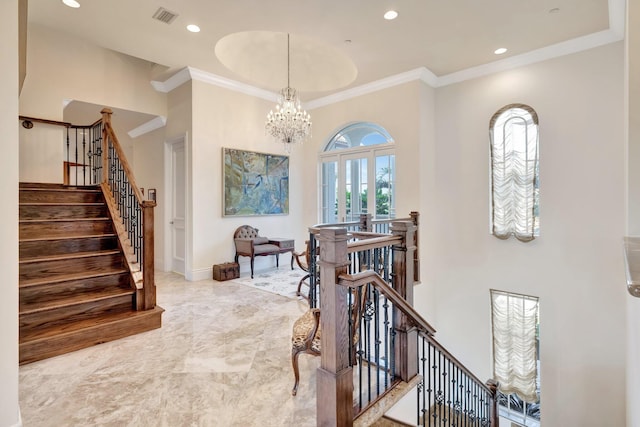 living area with a notable chandelier, crown molding, and french doors