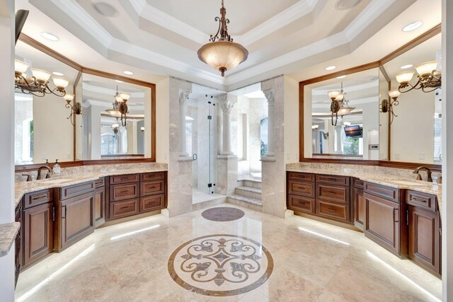 bathroom featuring a raised ceiling, decorative columns, and vanity