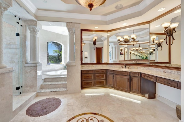 bathroom featuring ornate columns, crown molding, a tray ceiling, a shower with door, and vanity