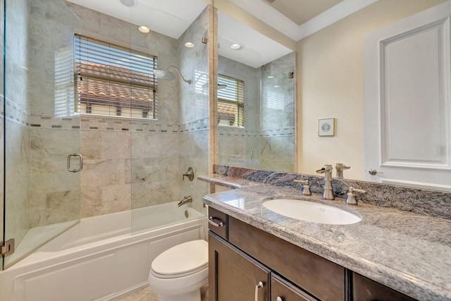 clothes washing area with cabinets, washing machine and dryer, and crown molding