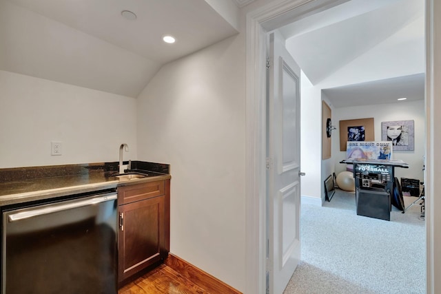 carpeted living room with ceiling fan and vaulted ceiling