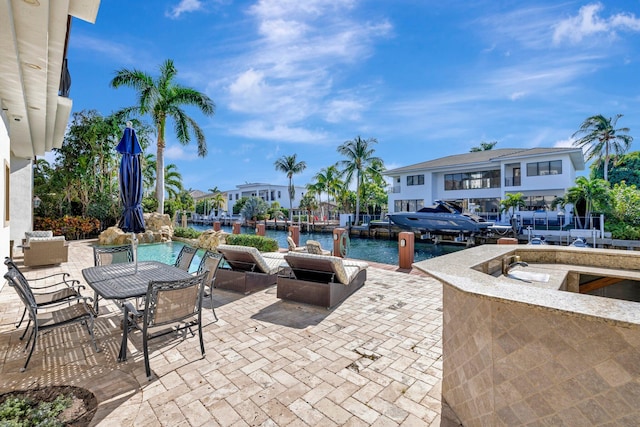 view of pool featuring a water view and a patio area