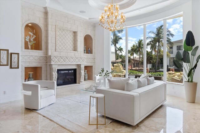 living room featuring ornamental molding, a high ceiling, a tray ceiling, and an inviting chandelier