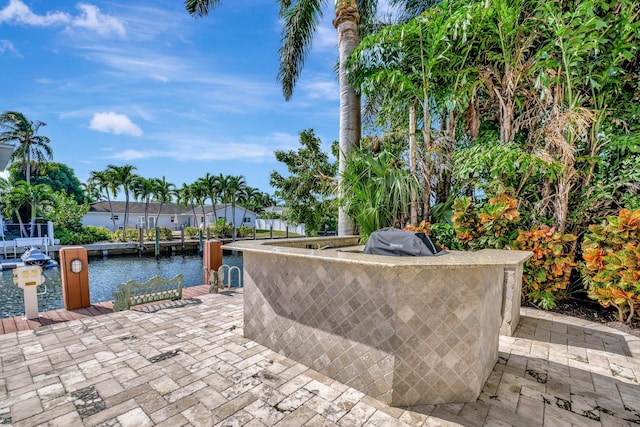 view of swimming pool with outdoor lounge area, a water view, and a patio