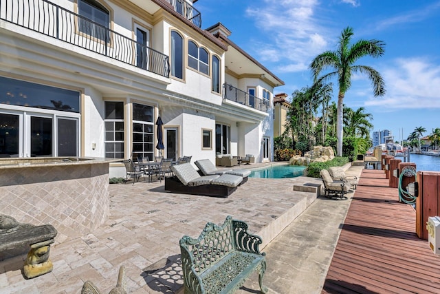 view of patio featuring a dock and a water view