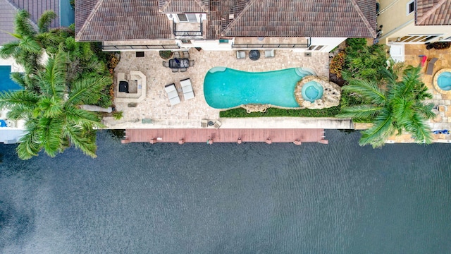 rear view of house with outdoor lounge area, a balcony, a patio area, and a water view