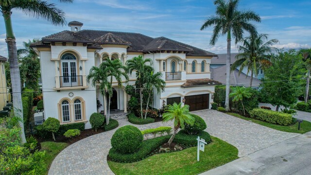 back of property with an outdoor hangout area, a balcony, a patio, and a water view