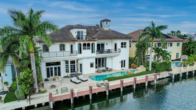 mediterranean / spanish house featuring a balcony, a front lawn, and a garage