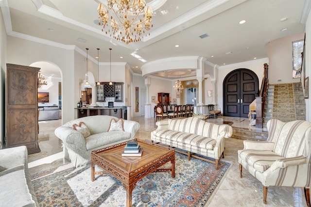 living room with a fireplace, a healthy amount of sunlight, a chandelier, and ornamental molding