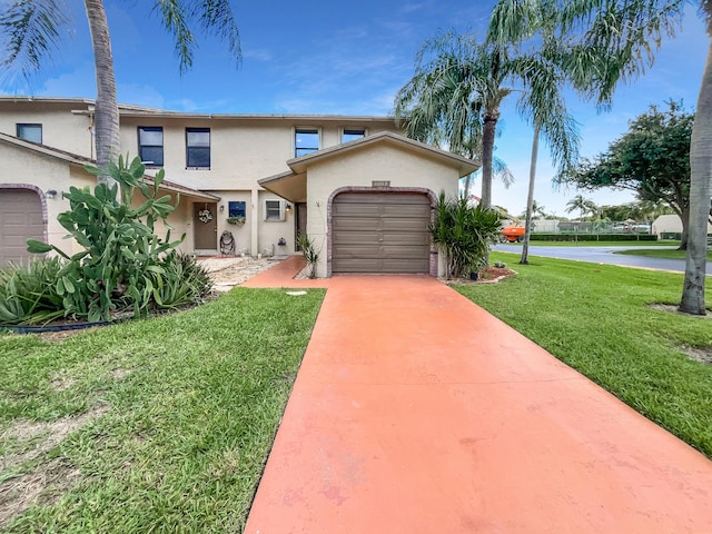 view of front of home featuring a front lawn and a garage