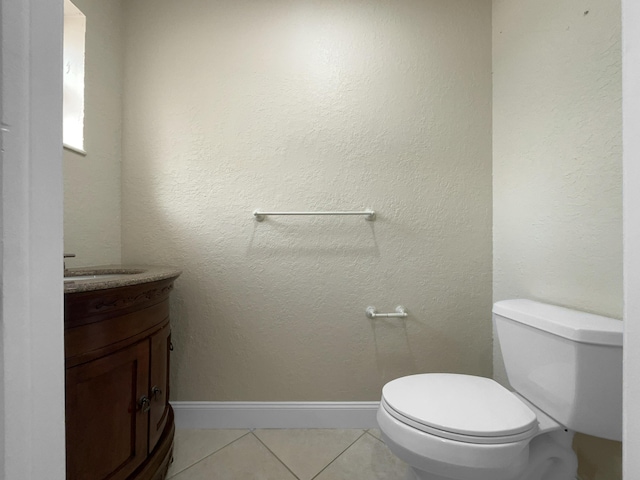 bathroom featuring toilet, vanity, and tile patterned floors