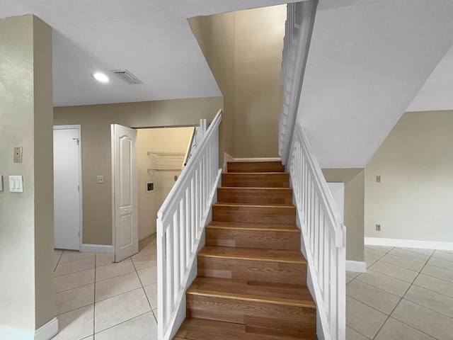 staircase with tile patterned flooring