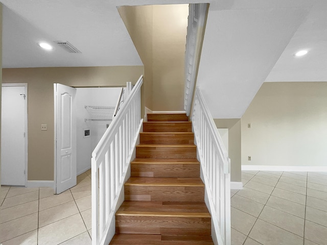 stairway with tile patterned floors