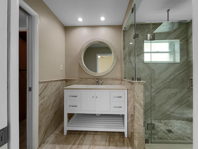 bathroom featuring vanity, tile walls, and a shower with shower door