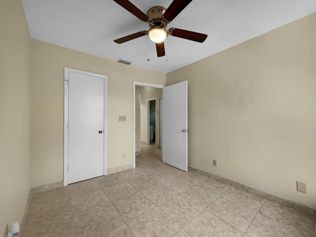 unfurnished bedroom with light tile patterned floors and ceiling fan