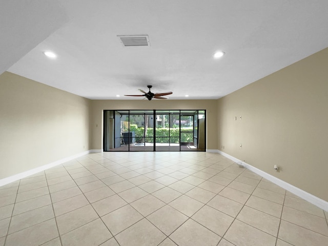 tiled spare room with ceiling fan