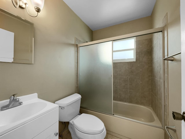 full bathroom with tile patterned flooring, vanity, bath / shower combo with glass door, and toilet