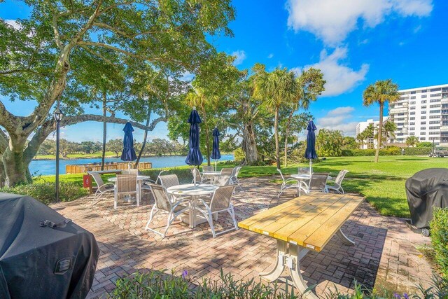 view of patio with a water view and grilling area