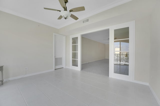 empty room featuring visible vents, a ceiling fan, ornamental molding, light tile patterned floors, and french doors