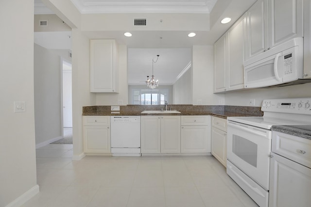 kitchen featuring a sink, visible vents, a notable chandelier, white appliances, and ornamental molding
