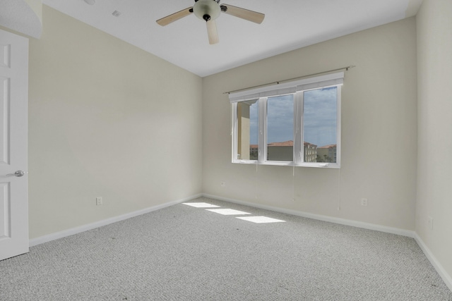 unfurnished room featuring carpet flooring, baseboards, and ceiling fan