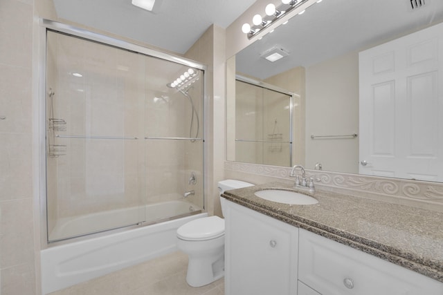 full bath with vanity, tile patterned flooring, enclosed tub / shower combo, and toilet