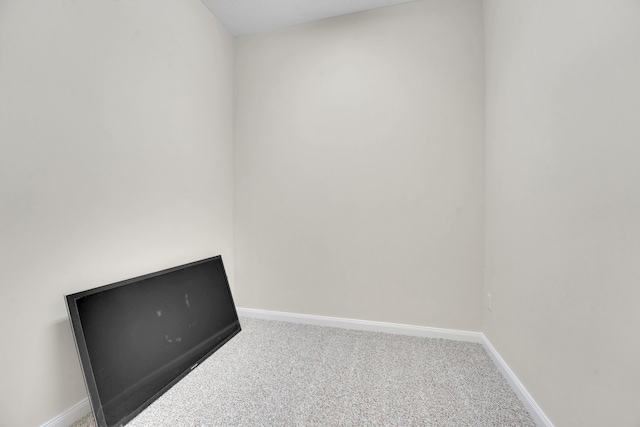 carpeted spare room with baseboards