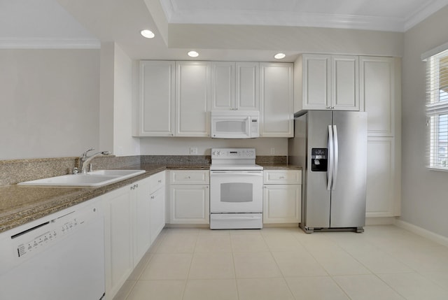 kitchen featuring white cabinetry, sink, dark stone countertops, ornamental molding, and white appliances