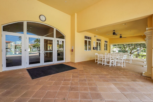view of patio / terrace featuring outdoor dining area, a ceiling fan, and french doors