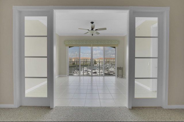 unfurnished room featuring light tile patterned floors, ornamental molding, and ceiling fan