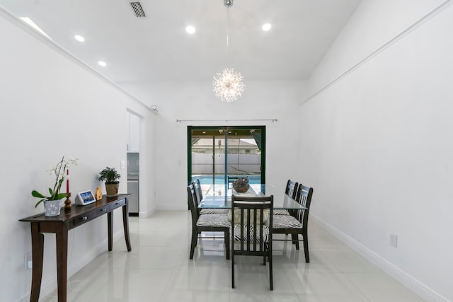 dining space with light tile patterned floors and a notable chandelier