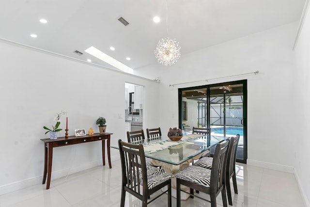 dining space with vaulted ceiling, an inviting chandelier, and light tile patterned flooring