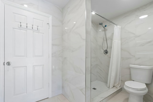 bathroom with toilet, tile patterned flooring, and walk in shower