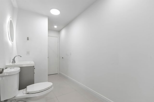 bathroom featuring tile patterned floors, vanity, and toilet