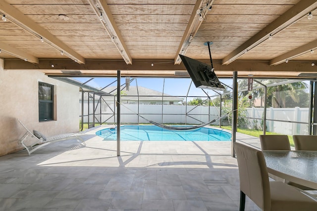 view of swimming pool with a lanai and a patio area