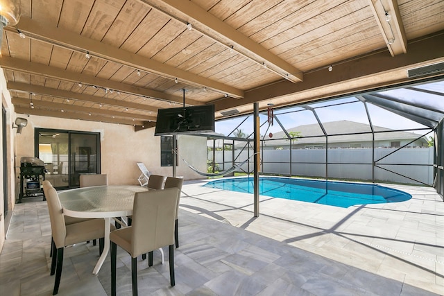 view of swimming pool featuring grilling area, a patio, and glass enclosure