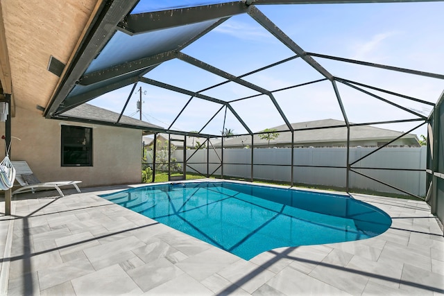 view of swimming pool with a lanai and a patio area