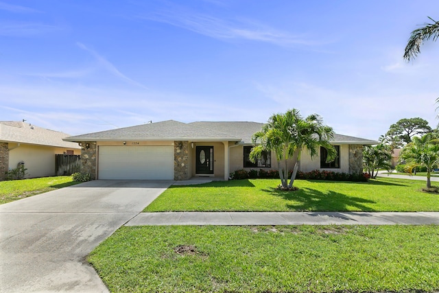 ranch-style home featuring a front lawn and a garage