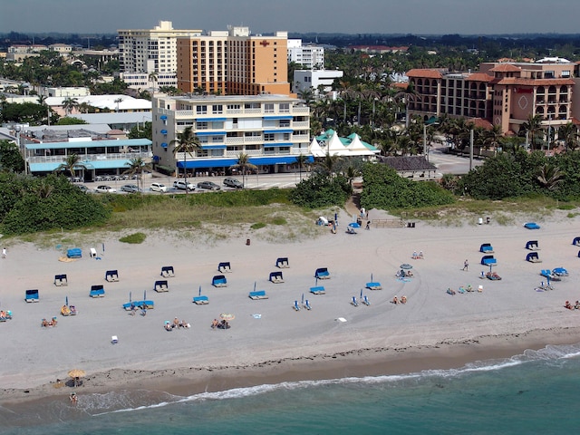 birds eye view of property with a view of the beach and a water view