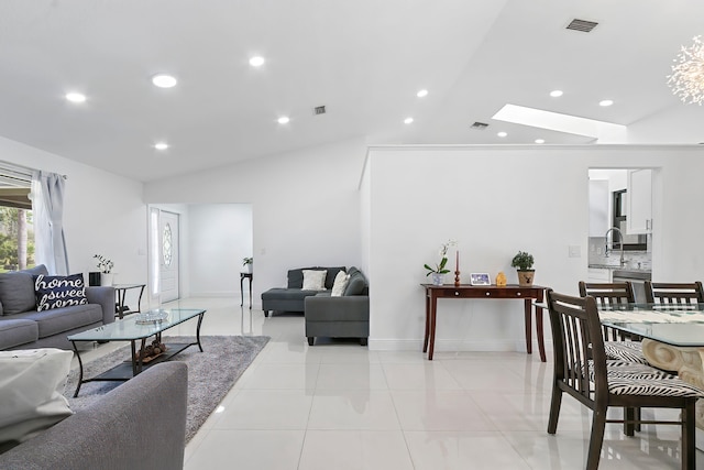 tiled living room featuring lofted ceiling with skylight