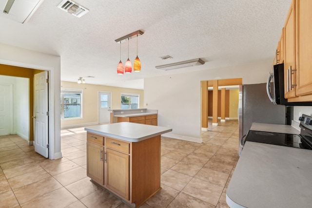 kitchen with a center island, a textured ceiling, range, pendant lighting, and light tile floors