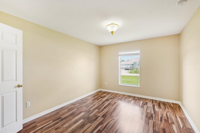 spare room featuring wood-type flooring