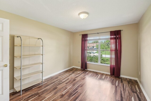 spare room with dark hardwood / wood-style floors