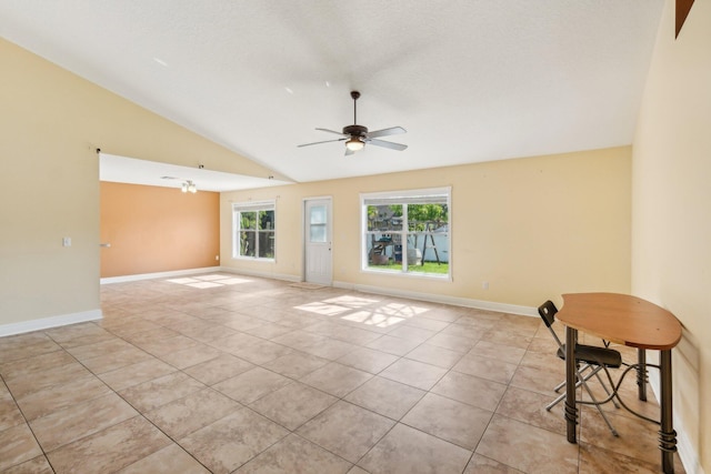 tiled spare room with lofted ceiling and ceiling fan