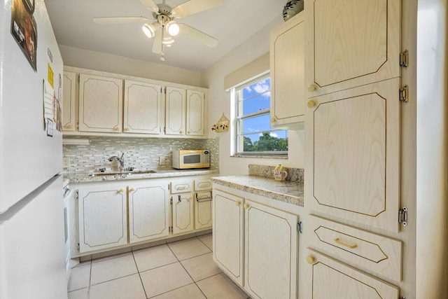 kitchen with decorative backsplash, white appliances, ceiling fan, sink, and light tile patterned floors