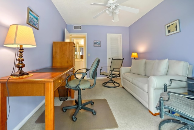 carpeted office space with ceiling fan